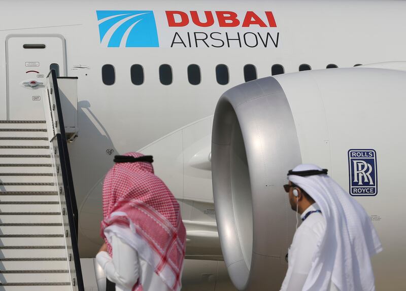 Emirati visitors walk past a Boeing 787-10 Dreamliner during the opening day of the Dubai Air Show, United Arab Emirates, Sunday, Nov. 12, 2017. The biennial Dubai Air Show opened Sunday with hometown long-haul carrier Emirates making a $15.1 billion buy of American-made Boeing 787-10 Dreamliners, as the world's biggest defense companies promoted their weapons amid heightened tensions between Saudi Arabia and Iran. (AP Photo/Kamran Jebreili)