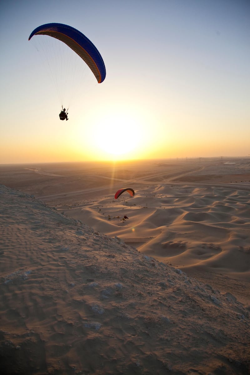 Members of the UAE paragliding group fly above the Al Wathba 'hill' in Abu Dhabi.  Deepthi Unnikrishnan/The National *** Local Caption ***  DU160213-Paragliding 13.jpg