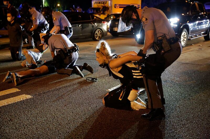 People are detained during protests Saturday near the Atlanta Wendy's where Rayshard Brooks was shot and killed by police. AP