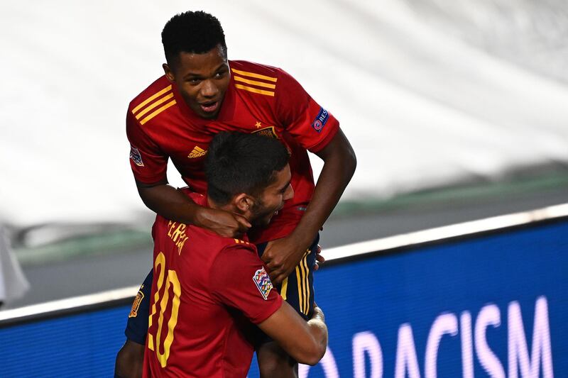 Ferran Torres celebrates with Ansu Fati, right, after scoring Spain's fourth goal. AFP