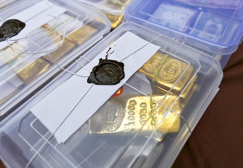Above, seized gold bars are kept on display at a police station in Ahmedabad. Amit Dave / Reuters
