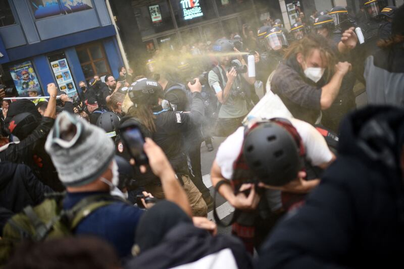 French police use spray against protesters during a rally against the soaring cost of living and climate inaction called by French left-wing coalition NUPES (New People's Ecologic and Social Union) in Paris. AFP