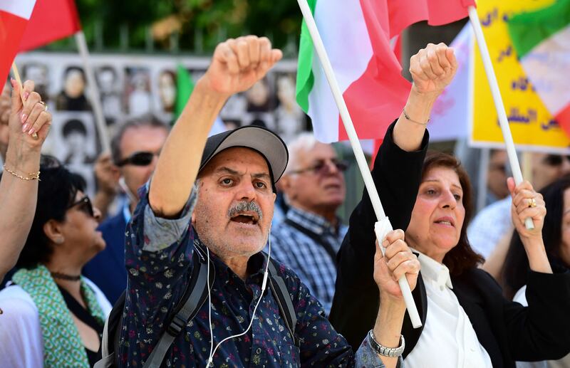 People outside Stockholm District Court in Stockholm, Sweden, on July 14 2022 after a life sentence was handed out to Hamid Nouri, a former official in Iran's judiciary accused of war crimes over the killing of prisoners in Iran during the 1980s. AFP