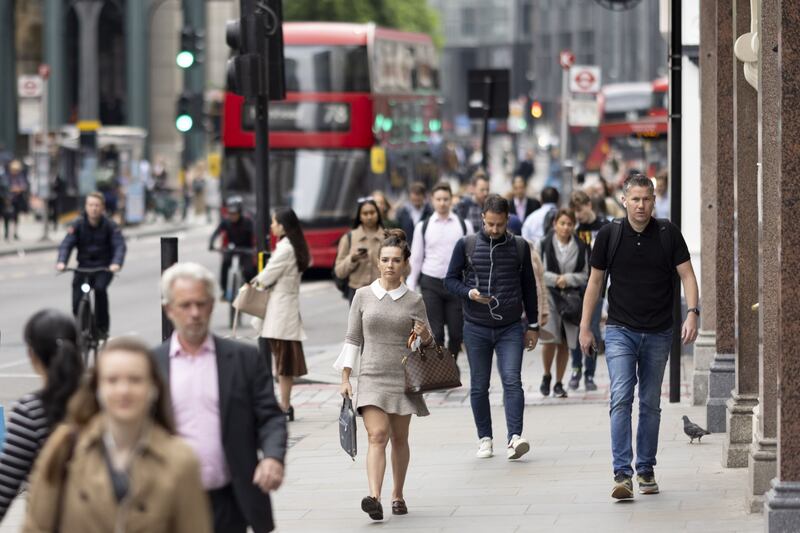 Morning commuters arrive in the City of London on May 16. Some will soon be working four-day weeks. Bloomberg