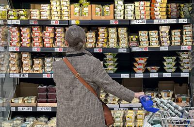 A customer shops for food items inside a Tesco supermarket in London. AFP