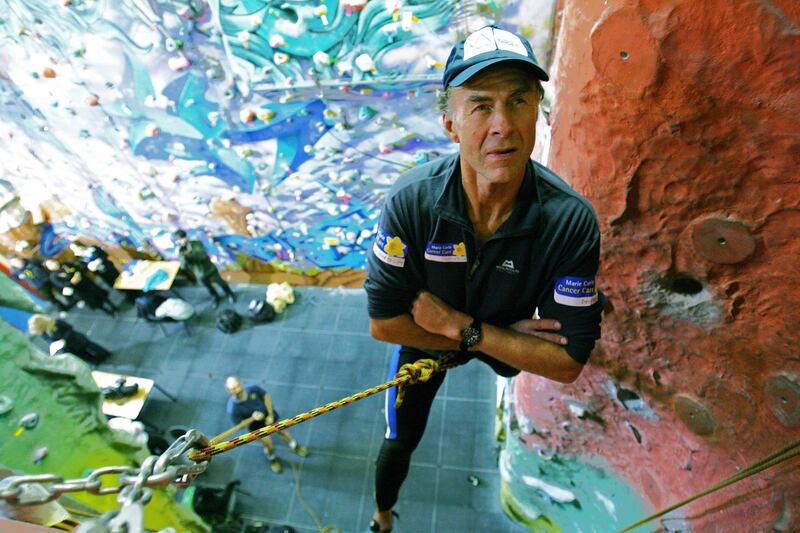 British Explorer, Sir Ranulph Fiennes, aged 62, scales a climbing wall during a press conference in East London, 26 February 2007. Fiennes will attempt to climb the north face of the Eiger Mountain in the Swiss Alps in March 2007 to raise money for the Marie Curie charity which cares for terminally ill patients. Fiennes suffers from vertigo, a heart condition and has lost fingers from his left hand to frost bite.  AFP PHOTO/CARL DE SOUZA / AFP PHOTO / CARL DE SOUZA