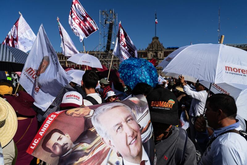 A supporter holds a poster featuring an image of Andres Manuel Lopez Obrador. Bloomberg