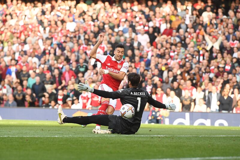 Gabriel Martinelli scores past Liverpool goalkeeper Alisson. EPA