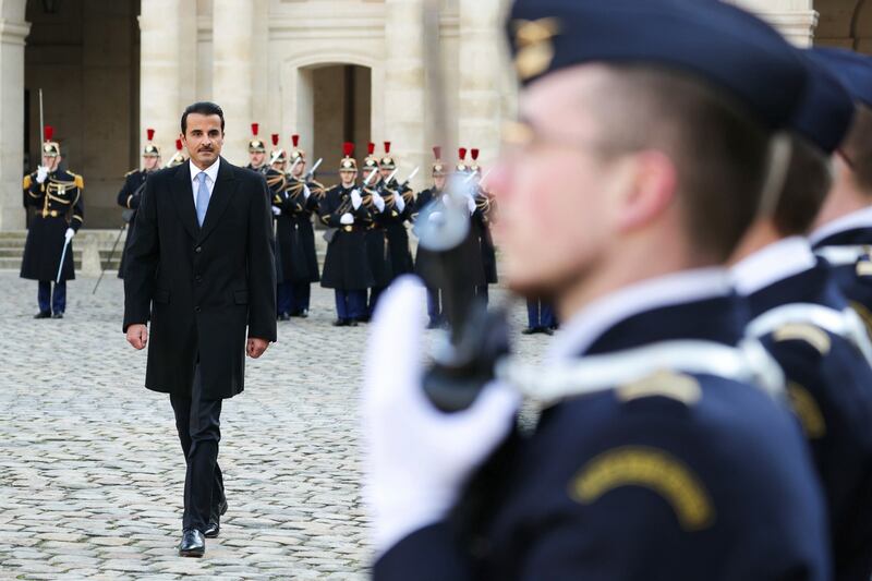 Sheikh Tamim inspects French troops in the courtyard of the Hotel des Invalides. AP