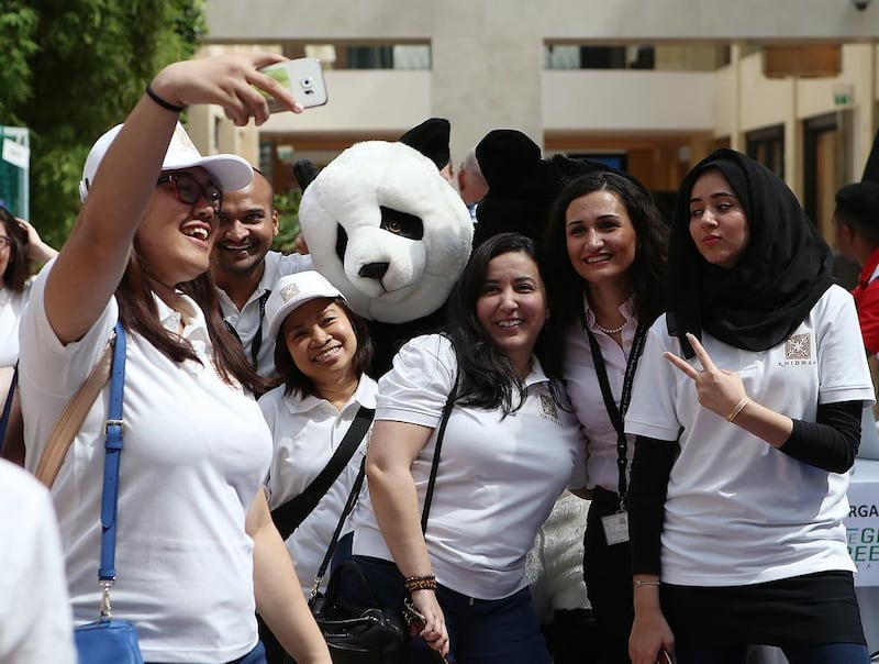 Participants take a selfie with a 'Panda' during the Great Green Race in Abu Dhabi. Ravindranath K / The National 