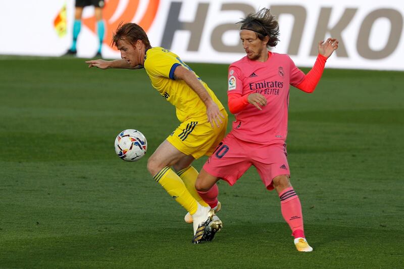 Real Madrid midfielder Luka Modric, right, in action against Cadiz's Alex Fernandez. EPA