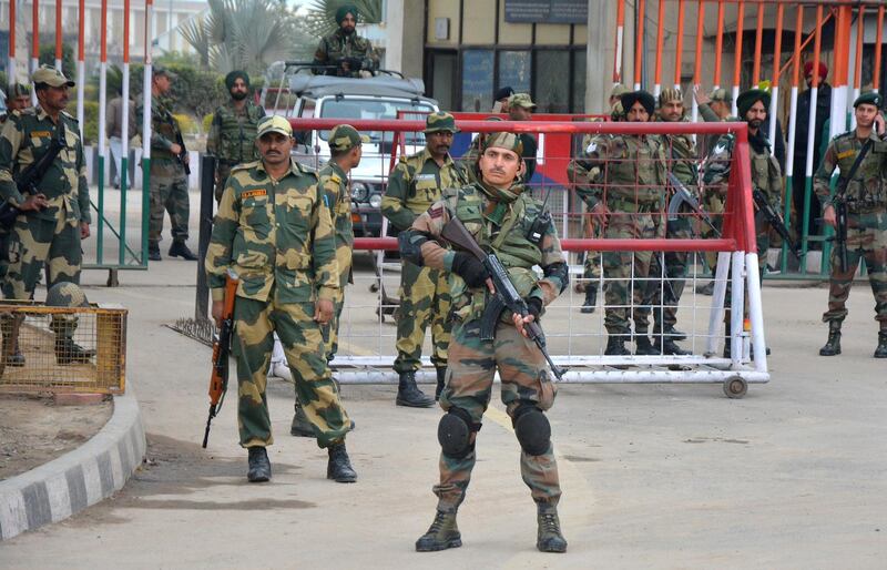 Indian army soldiers stand guard outside integrated check post at Atari from where Indian fighter pilot Wing Commander Abhinandan Varthaman is to enter, at India Pakistan border Wagah, 28 kilometers (17.5 miles) from Amritsar, India, Friday, March 1, 2019. Pakistani officials brought a captured Indian pilot to a border crossing with India for handover on Friday, a "gesture of peace" promised by Pakistani Prime Minister Imran Khan amid a dramatic escalation with the country's archrival over the disputed region of Kashmir. (AP Photo/Prabhjot Gill)