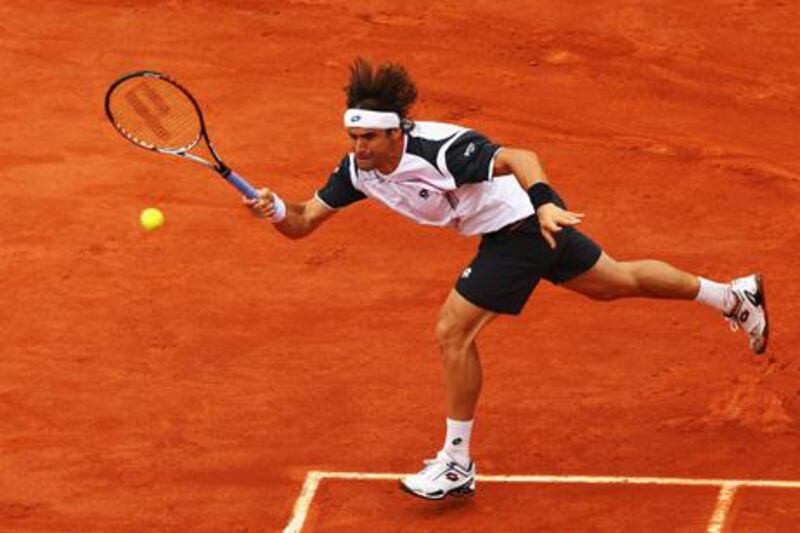 PARIS, FRANCE - JUNE 04:  David Ferrer of Spain plays a forehand in his men's singles fourth round match against Marcel Granollers of Spain during day 9 of the French Open at Roland Garros on June 4, 2012 in Paris, France.  (Photo by Clive Brunskill/Getty Images)