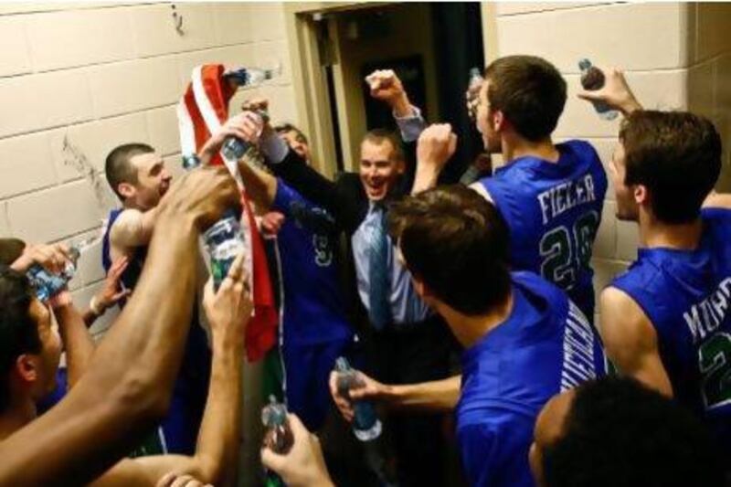 Florida Gulf Coast players celebrate with coach Andy Enfield, centre, after their surprising upset win over San Diego State. Scott McIntyre / AP Photo