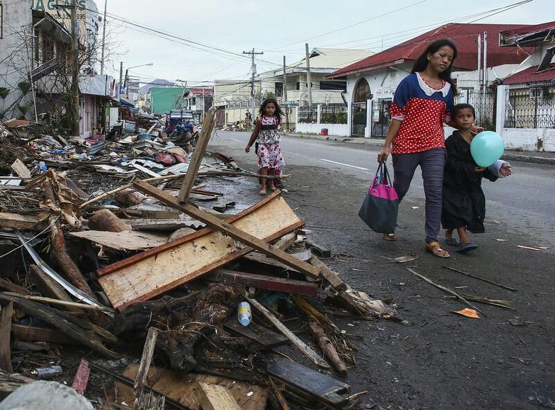 A reader says people wanting to help Philippines typhoon victims should deal with recognised charities such as the Red Crescent, which will ensure their money is directed to where it is needed. Nic Bothma / EPA