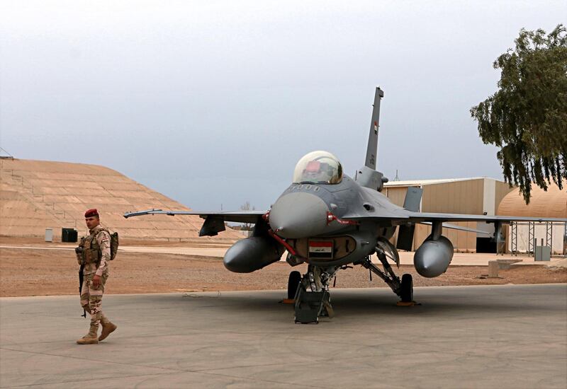 FILE - in this Tuesday, Feb. 13, 2018 file photo, an Iraqi army soldier stand guard near a U.S.- made Iraqi Air Force F-16 fighter jet at the Balad Air Base, Iraq. Security measures have been increased at one of the countryâ€™s largest air bases that houses American trainers, following an attack last week, a top Iraqi air force commander said Saturday, June 22, 2019 while the U.S. military said operations at the base are going on as usual and there are no plans to evacuate personnel at the present time.  (AP Photo/Khalid Mohammed, File)