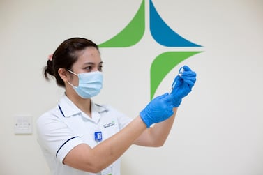 A nurse prepares a shot of the Pfizer-BioNTech coronavirus vaccine in Dubai. Dubai Media Office / EPA