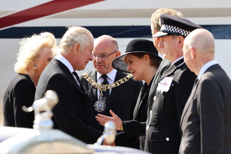 King Charles talks with Scotland's First Minister Nicola Sturgeon as he arrives at Edinburgh Airport. Reuters