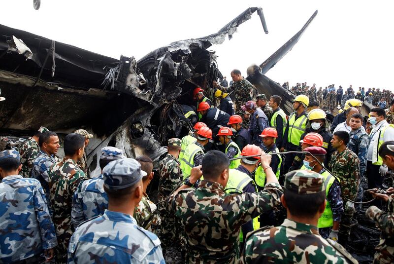 Rescue teams search for people in the wreckage of a plane that crashed at the main airport Tribhuvan International Airport in Kathmandu, Nepal, on March 12, 2018. Narendra Shrestha / EPA