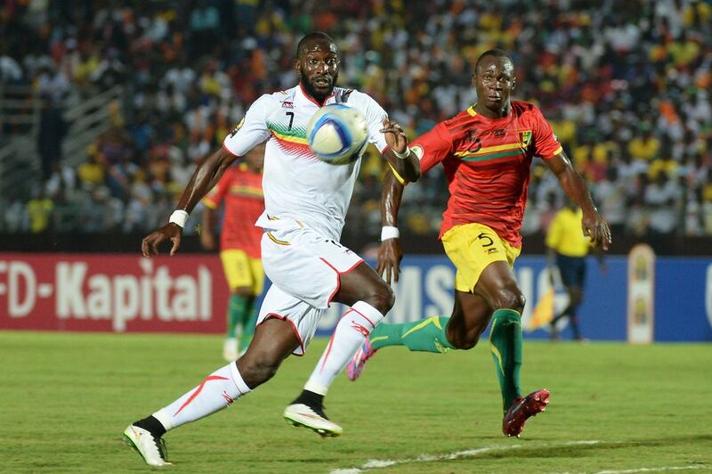 Mali forward Mustapha Yatabare, left, vies with Guinea defender Fode Camara during the African Cup of Nations group D match on January 28, 2015. Khaled Desouki / AFP