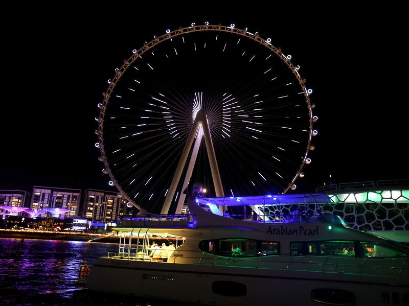 The light show identifies the landmark wheel at Bluewaters Island, Dubai