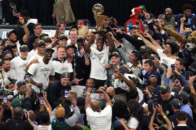 Khris Middleton of the Milwaukee Bucks celebrates with the rest of the team.