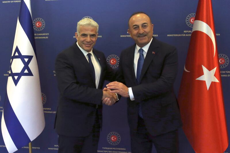 Turkish Foreign Minister Mevlut Cavusoglu, right, and Israeli Foreign Minister Yair Lapid before their talks in Ankara in June 2022. AP