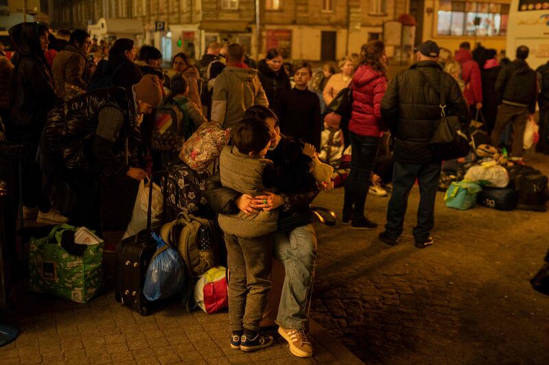 Refugees from Ukraine wait to get on buses to other destinations in Poland outside the train station in Przemysl. AFP