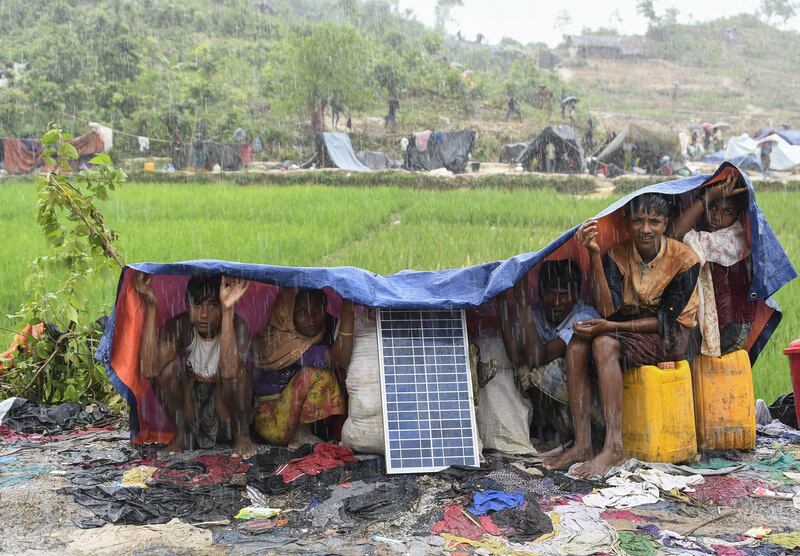 Rohingya refugees protect themselves from the rain in Bangladesh's Balukhali refugee camp. Dominique Faget
/ AFP PHOTO