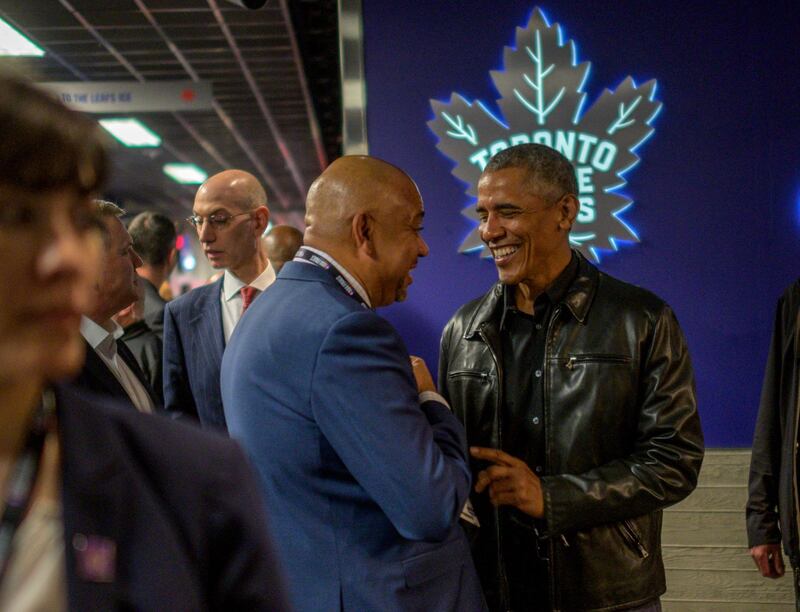 Former US president Barack Obama talks with ESPN sports commentator Michael Wilson. EPA