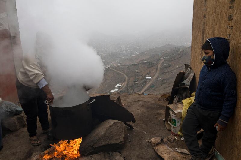 Elena Toribio cooks lentils at a soup kitchen of the Nueva Esperanza neighborhood, on the outskirts of Lima, Peru. AP Photo