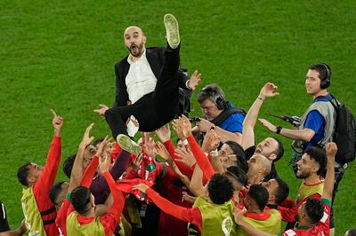 Morocco manager Walid Regragui is given the bumps by his players after the World Cup Round of 16 victory against Spain at the Education City Stadium in Al Rayyan, Qatar, on Tuesday, December 6, 2022.  AP 