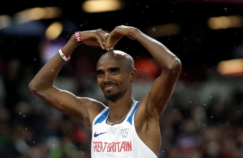 Britain's Mo Farah makes the Mobot before a men's 5000-meter first round heat during the World Athletics Championships in London Wednesday, Aug. 9, 2017. (AP Photo/Matt Dunham)