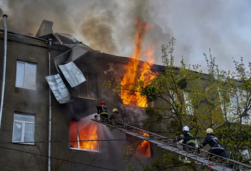 Firefighters at work in the aftermath of a Russian shelling in Kharkiv. EPA