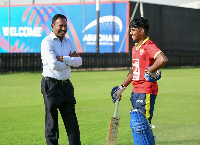 Ethan D'Souza with his father John at the Zayed Cricket Stadium. Khushnum Bhandari / The National
