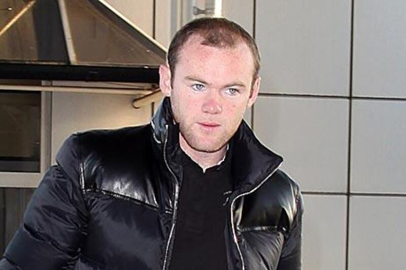 Wayne Rooney heads for his flight to the US.