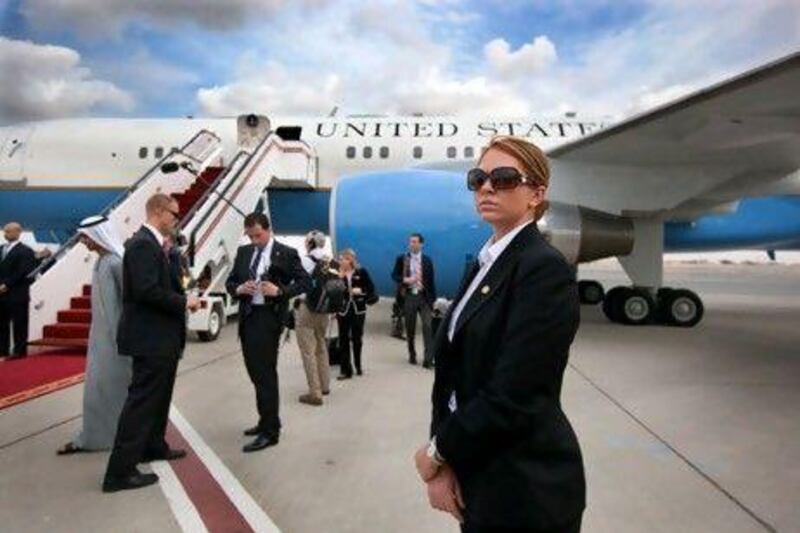 Brittany Cross, foreground, and other members of Hillary Clinton's security detail keep watch during a trip in the United Arab Emirates.