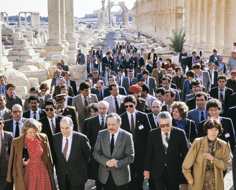 French President Francois Mitterrand, his wife Danielle (R) and the Syrian chief archaeologist of the ancient city of Palmyra, Khaled al-Assaad (2ndR) visit the ancient oasis city of Palmyra on November 27, 1984. The Islamic State (IS) group beheaded Al-Assaad, who refused to leave the ancient city when the jihadists captured it, on August 19, 2015, Syria's antiquities chief Maamoun Abdulkarim said. AFP PHOTO / PHILIPPE BOUCHON (Photo by PHILIPPE BOUCHON / AFP)