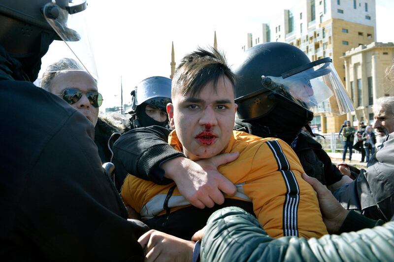 Lebanese riot police arrest an anti-government protester trying to prevent Parliament members from reaching the Parliament to attend the 2020 budget discussion session, in downtown Beirut.  EPA