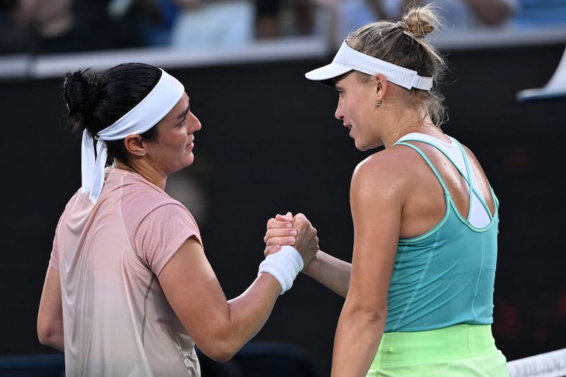 Ons Jabeur shakes hands with Yuliia Starodubtseva at the net following their match. AFP