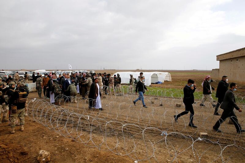 Security forces check attendees before the funeral. Reuters