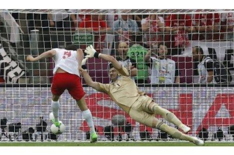 Poland’s Robert Lewandowski, left, scored the first of 20, so far, headed goals in Euro 2012.