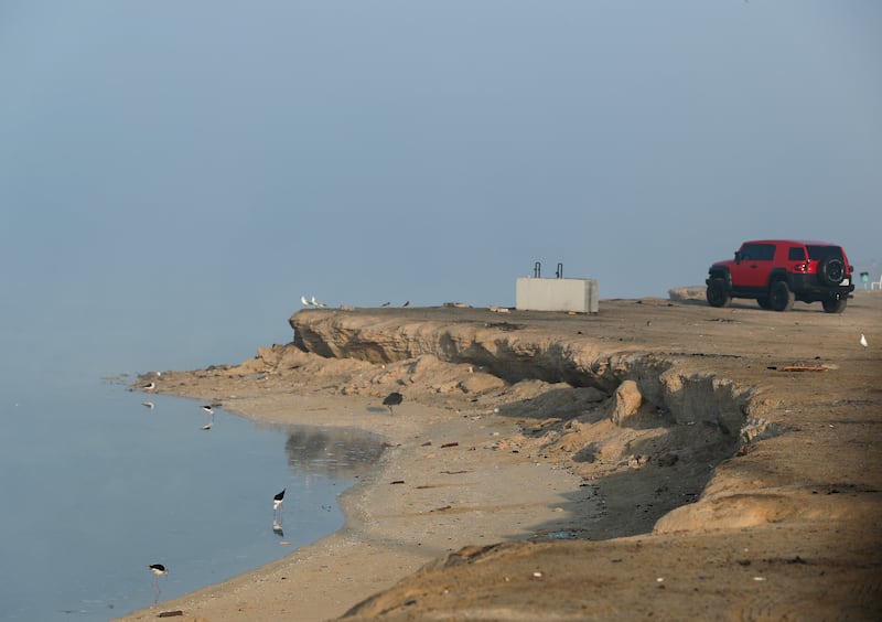 A motorist stops to enjoy the view at Al Bahia Open Beach.