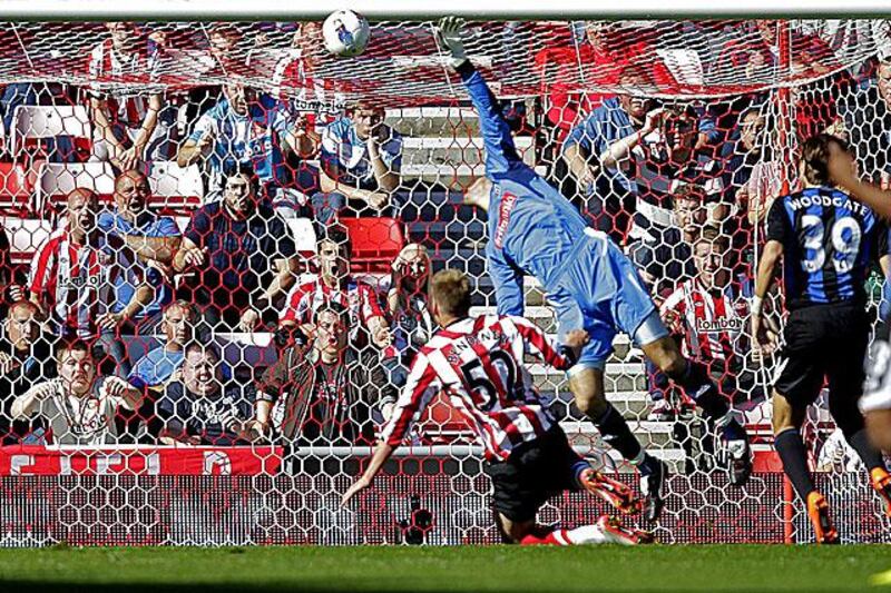 Asmir Begovic, the Stoke goalkeeper, stretches in vain to keep out an header from his own central-defender, Jonathan Woodgate, right, as Sunderland ran rampant against Stoke.

Graham Stuart / AFP