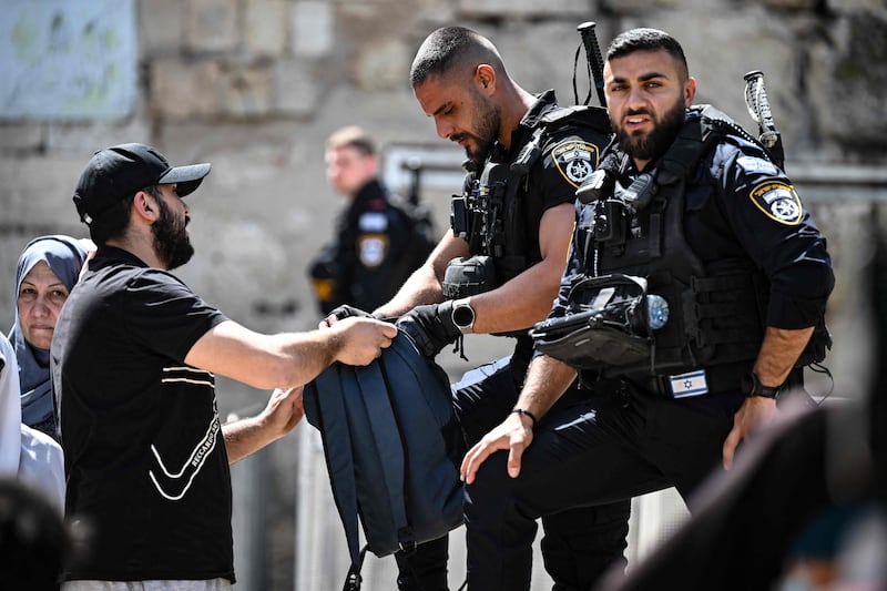 Palestinians being checked by Israeli soldiers as they head to the Al Aqsa Mosque compound. AFP