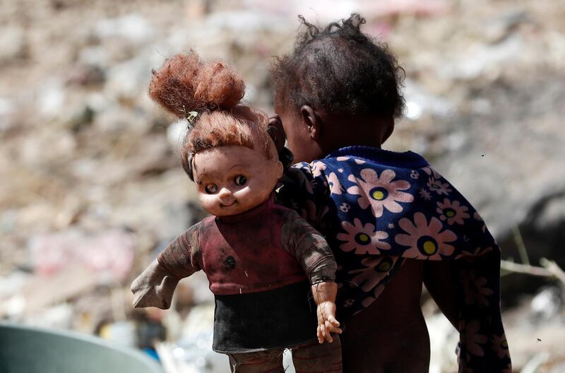 A displaced Yemeni child holds a doll at a camp for Internally Displaced Persons (IDPs) on the outskirts of Sanaa. EPA