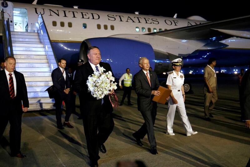 US Secretary of State Mike Pompeo holds flowers he received on arrival to New Delhi. Reuters