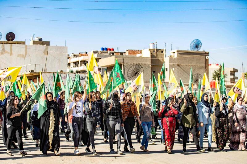 Syrian Kurdish women carry party flags, as they take part in a rally in the northeastern Syrian city of Qamishly. AFP