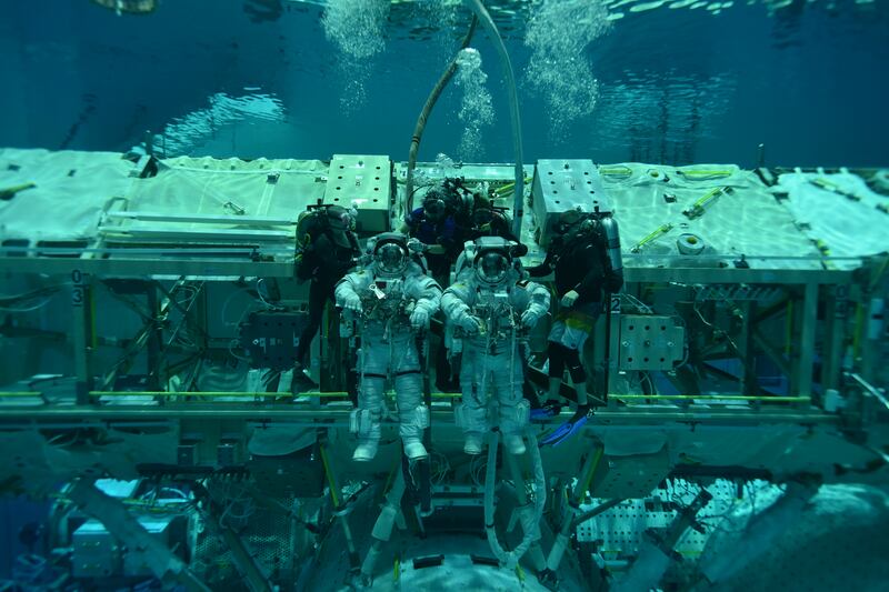 UAE astronauts Mohammed Al Mulla and Nora Al Matrooshi underwater during their spacewalk training.