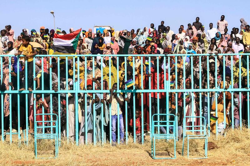 People watch as fighters from the army-aligned Sudan Liberation Movement attend a graduation ceremony in the south-eastern Gedaref state on March 28. AFP